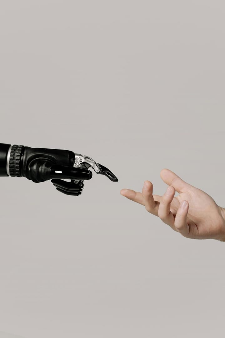 Robotic hand reaching toward a human hand, representing the impact of AI on strategic IT procurement and sourcing decisions.
