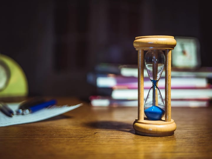 Hourglass on desk representing time and decision-making in IT procurement