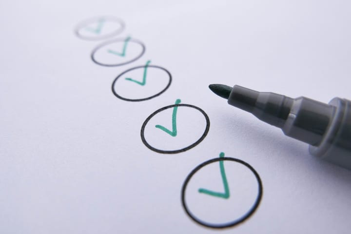 Checklist with green tick marks being completed, representing internal readiness and decision-making before enterprise AI vendor evaluation.